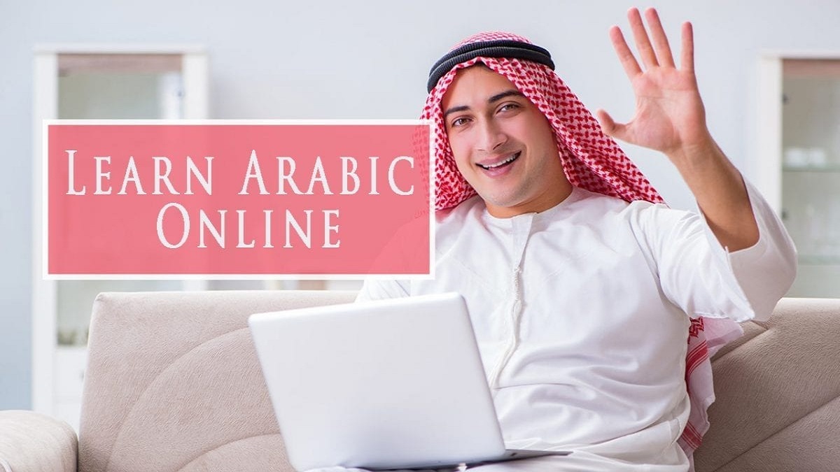 Man in traditional Arab attire waving at laptop - Learn Arabic Online