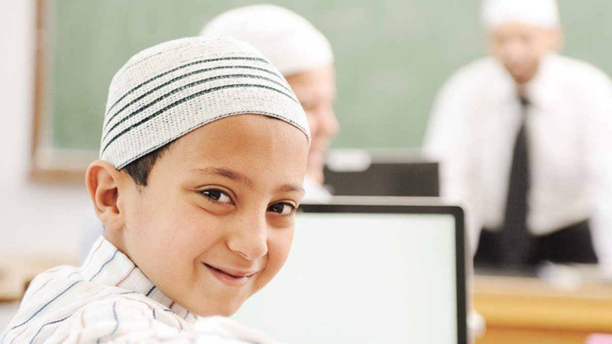 Smiling young boy ready to learn Noorani Qaida online