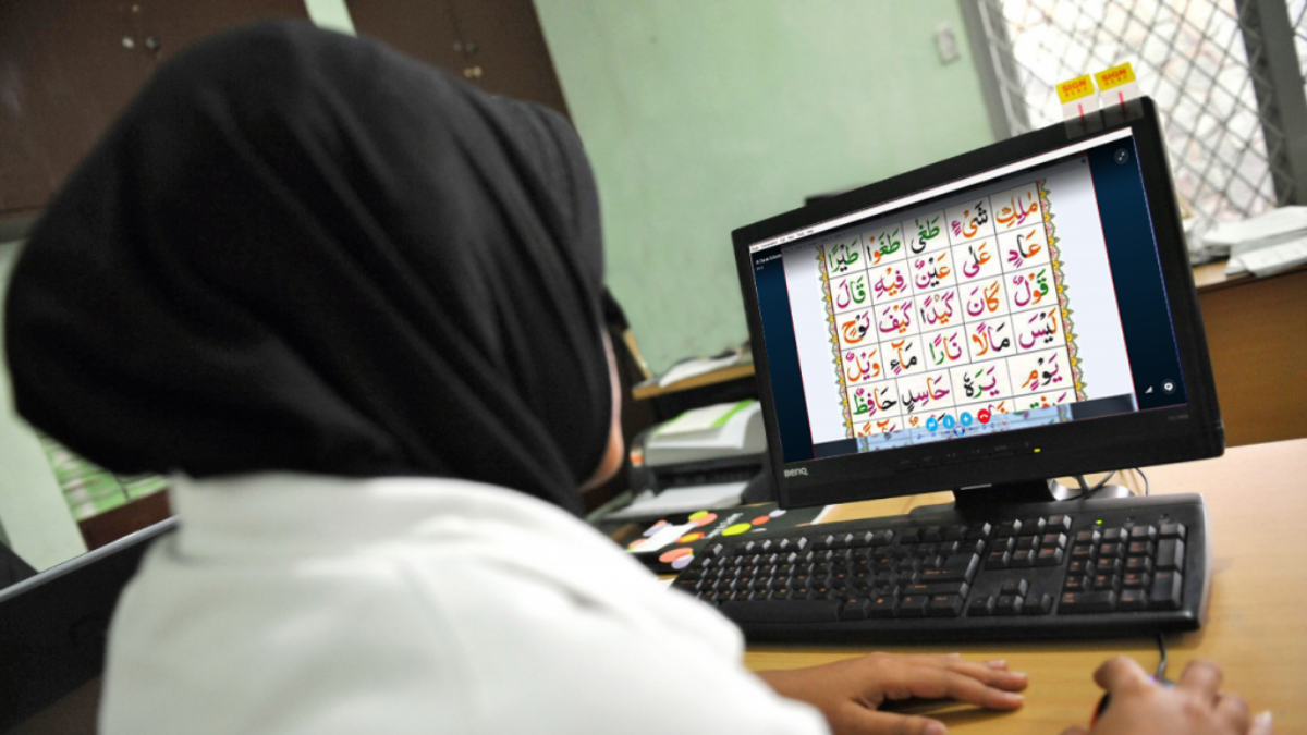Student learning Quran online on a computer