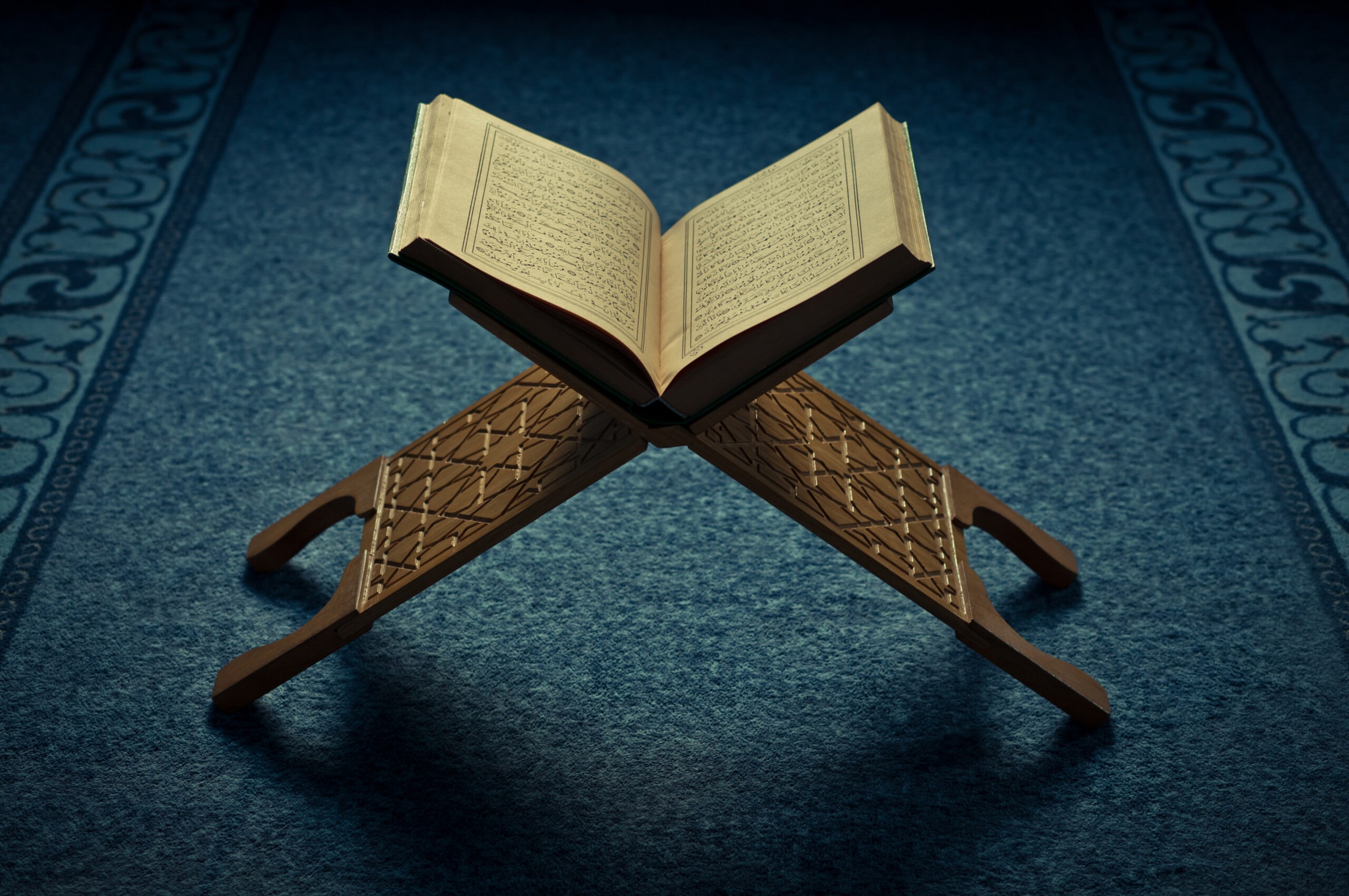 Open Quran on a wooden Rehal (stand)